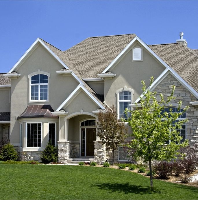 A large house with a large lawn in front of it