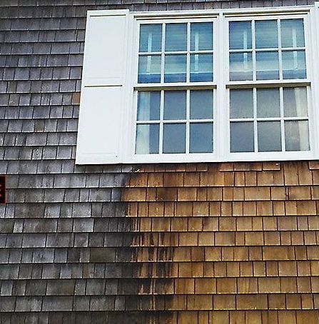 A house with wooden siding and a window with white shutters.