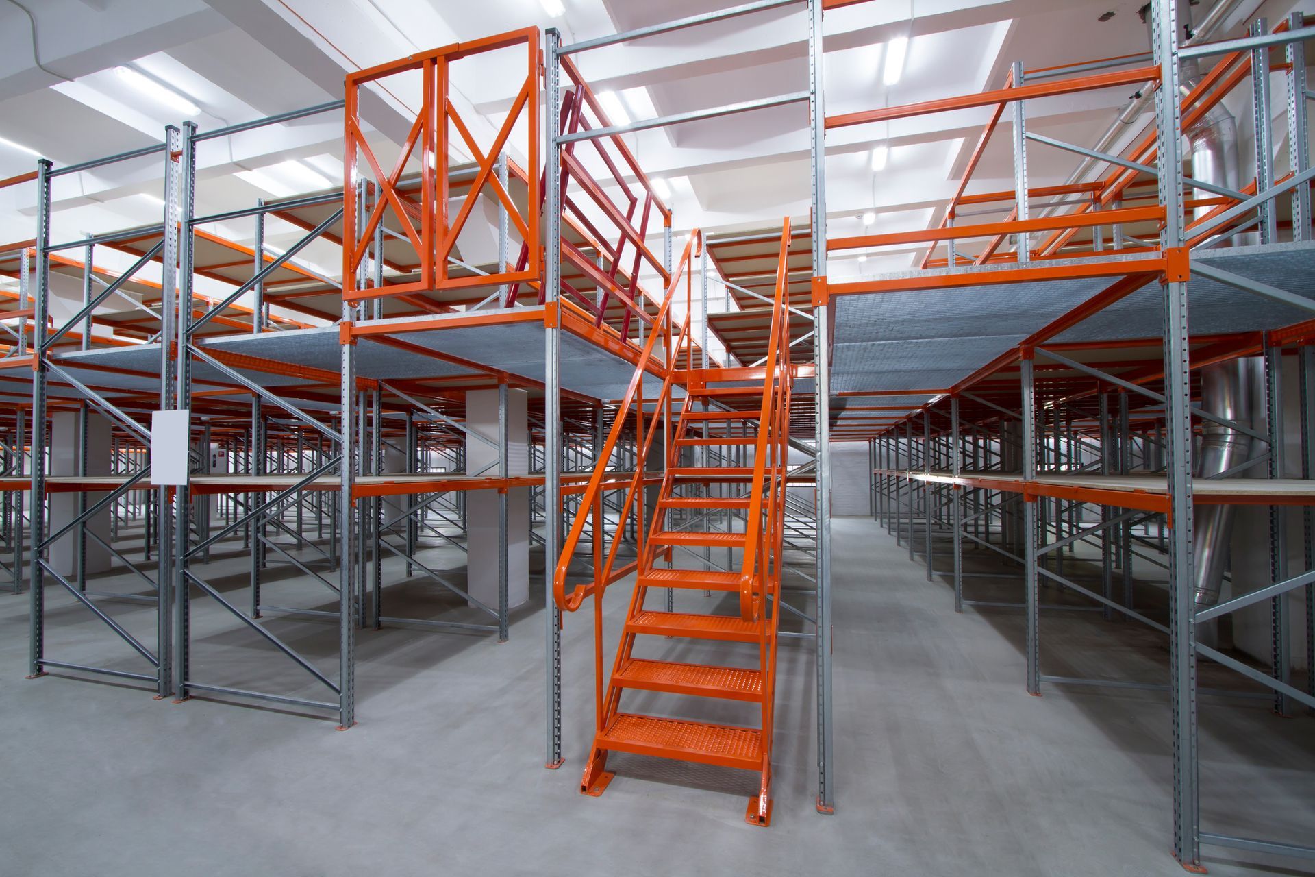 Blue shelves in a narrow aisle, empty and ready for storage in a warehouse or similar setting.
