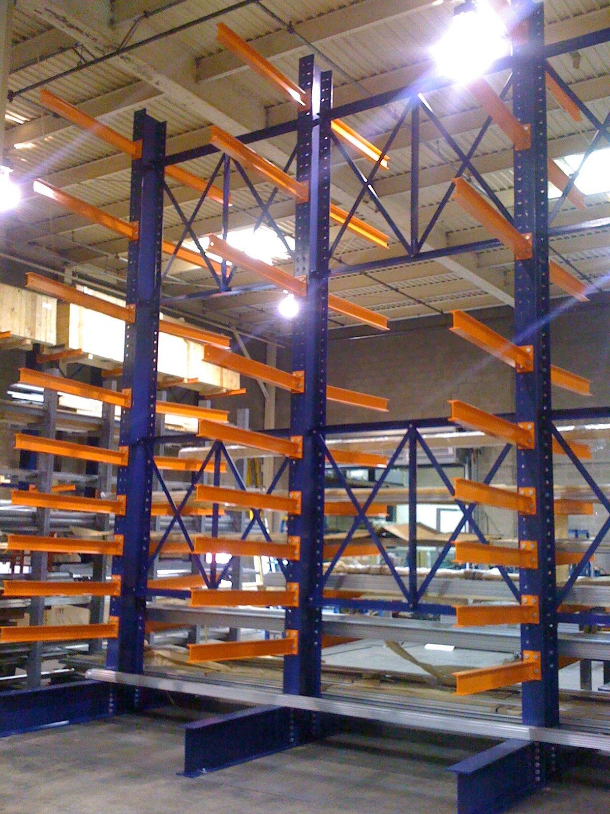 Blue and orange cantilever racking in a warehouse, designed for storing long items.