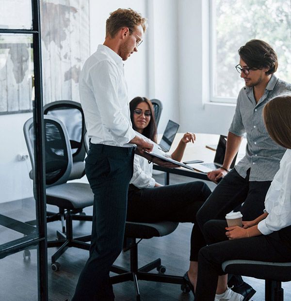 A group of people are having a meeting in an office