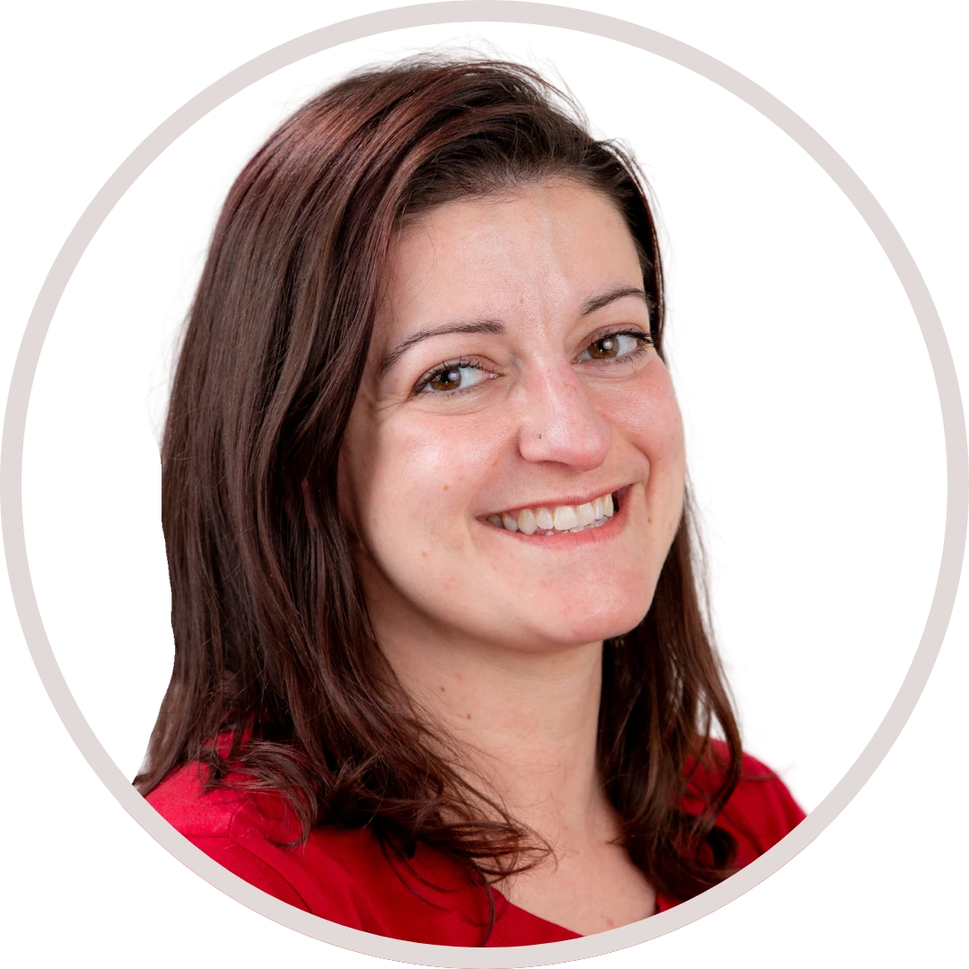 Woman with dark hair smiles, wearing a red shirt, inside a white circle.