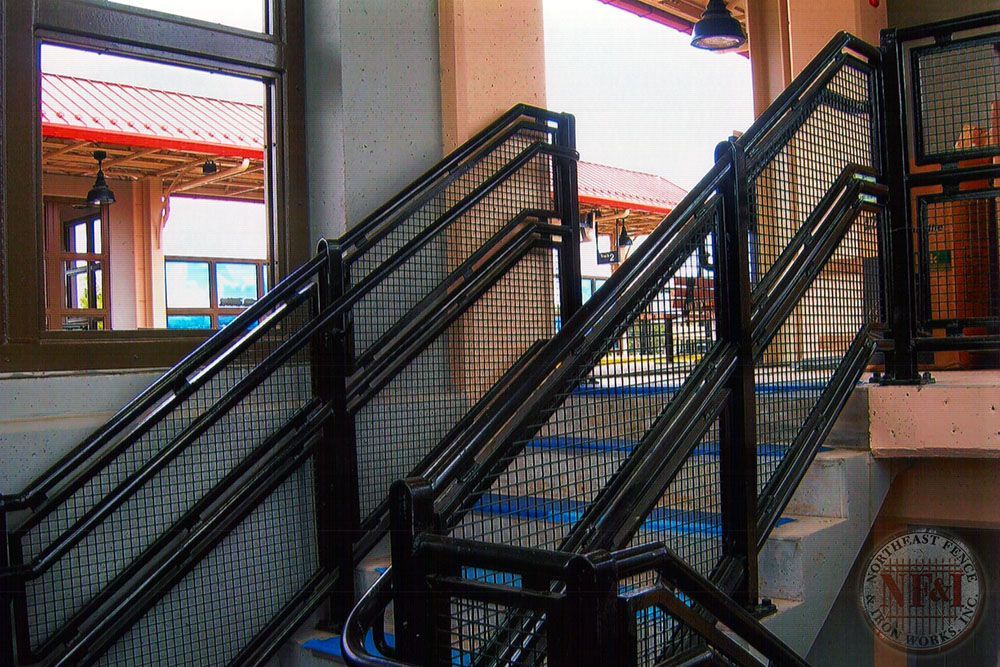 A staircase with a metal railing and a sign that says nm