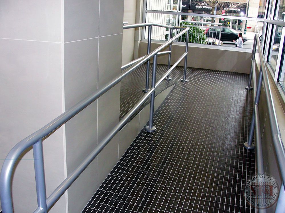 A ramp with a metal railing on the side of it