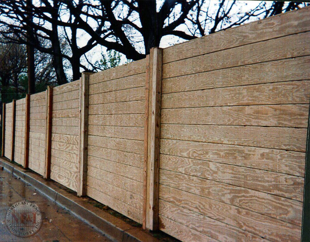 A wooden fence with trees in the background
