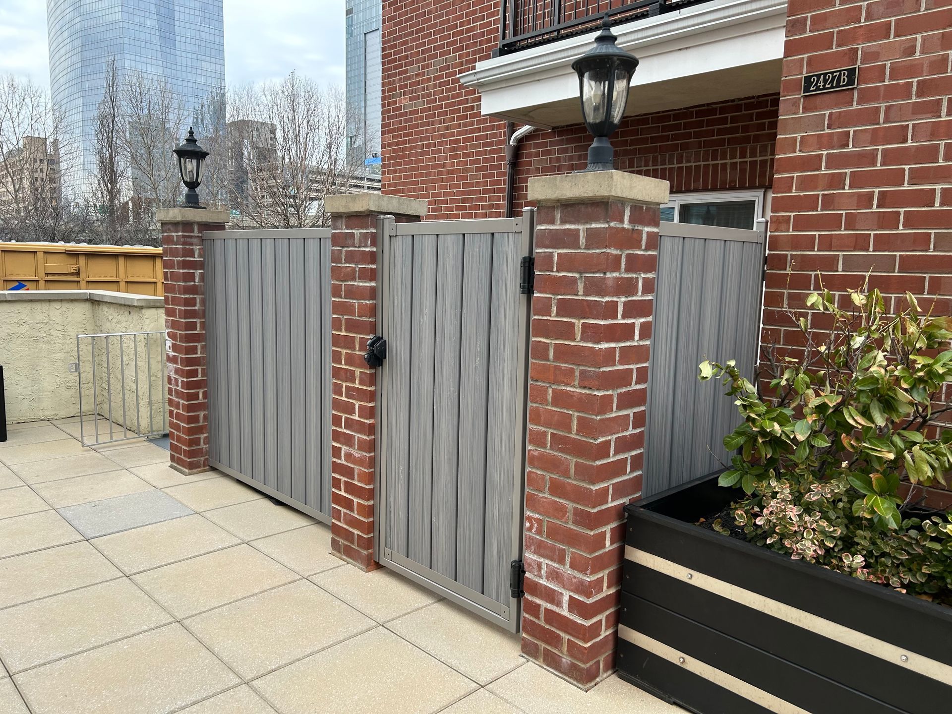 A brick building with a wooden gate in front of it.