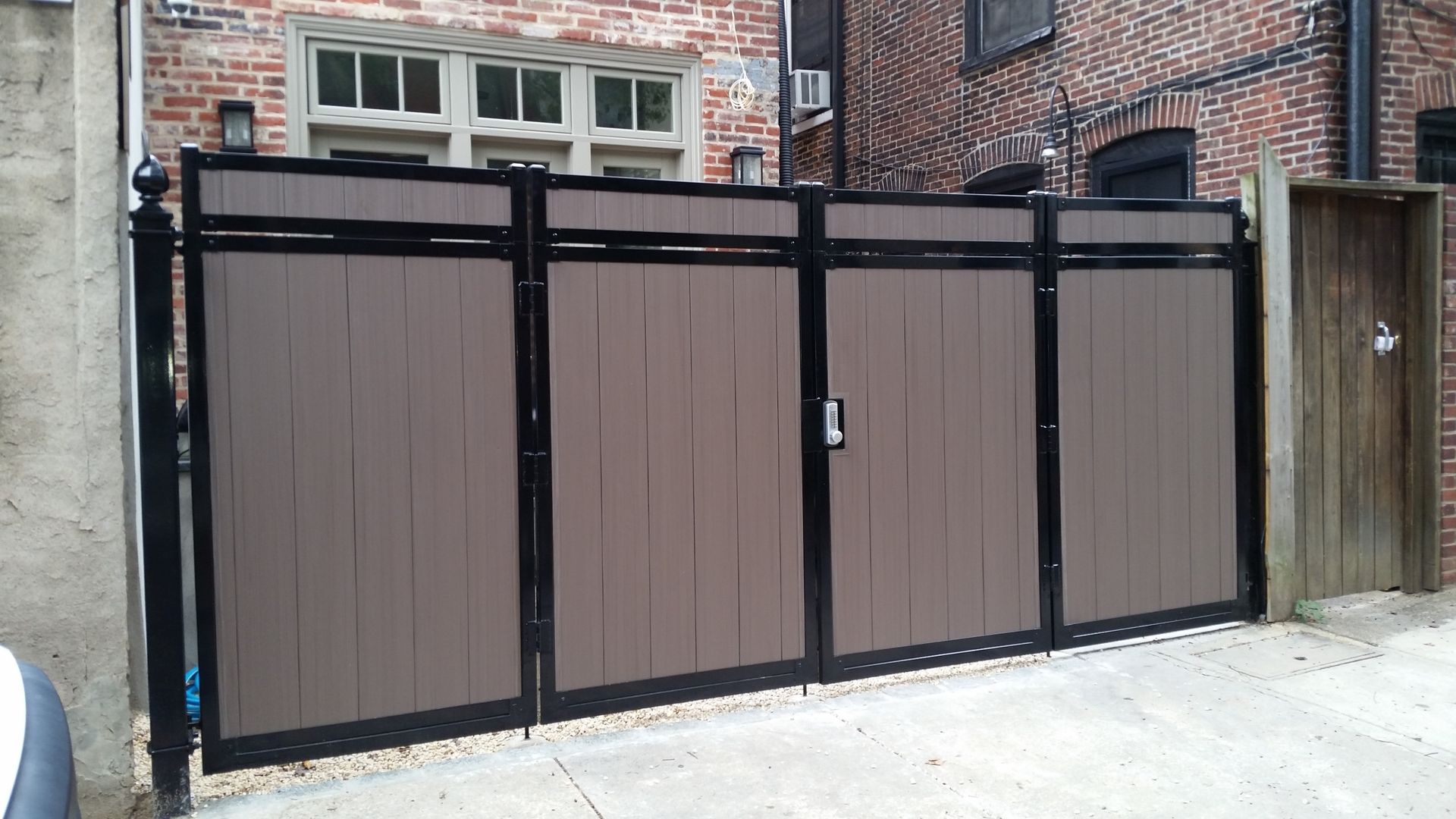 A brick building with a wooden gate in front of it