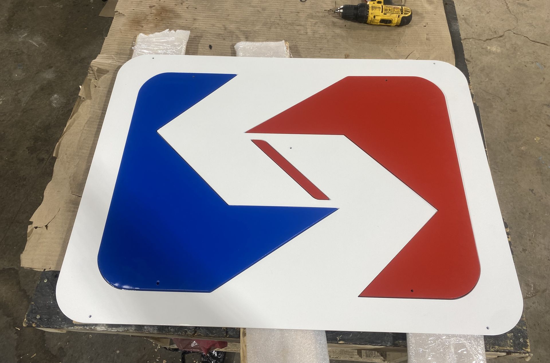 A red white and blue sign is sitting on a table