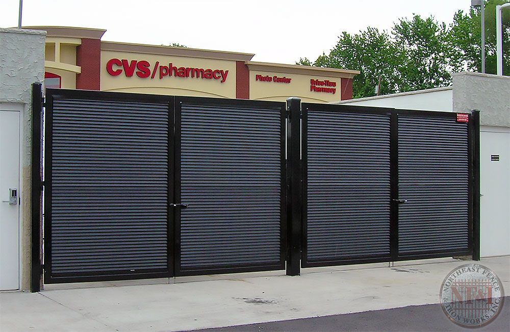 A cvs / pharmacy building with a black gate in front of it