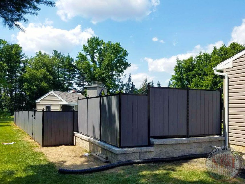 There is a fence in the backyard of a house.