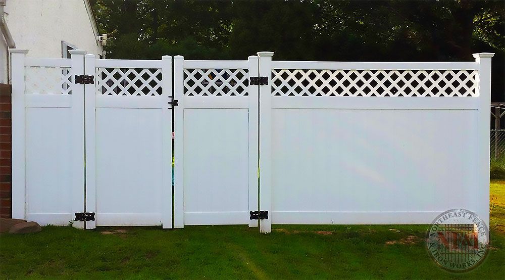A white fence with a lattice design and a gate