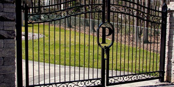 A wrought iron gate with the letter p on it.