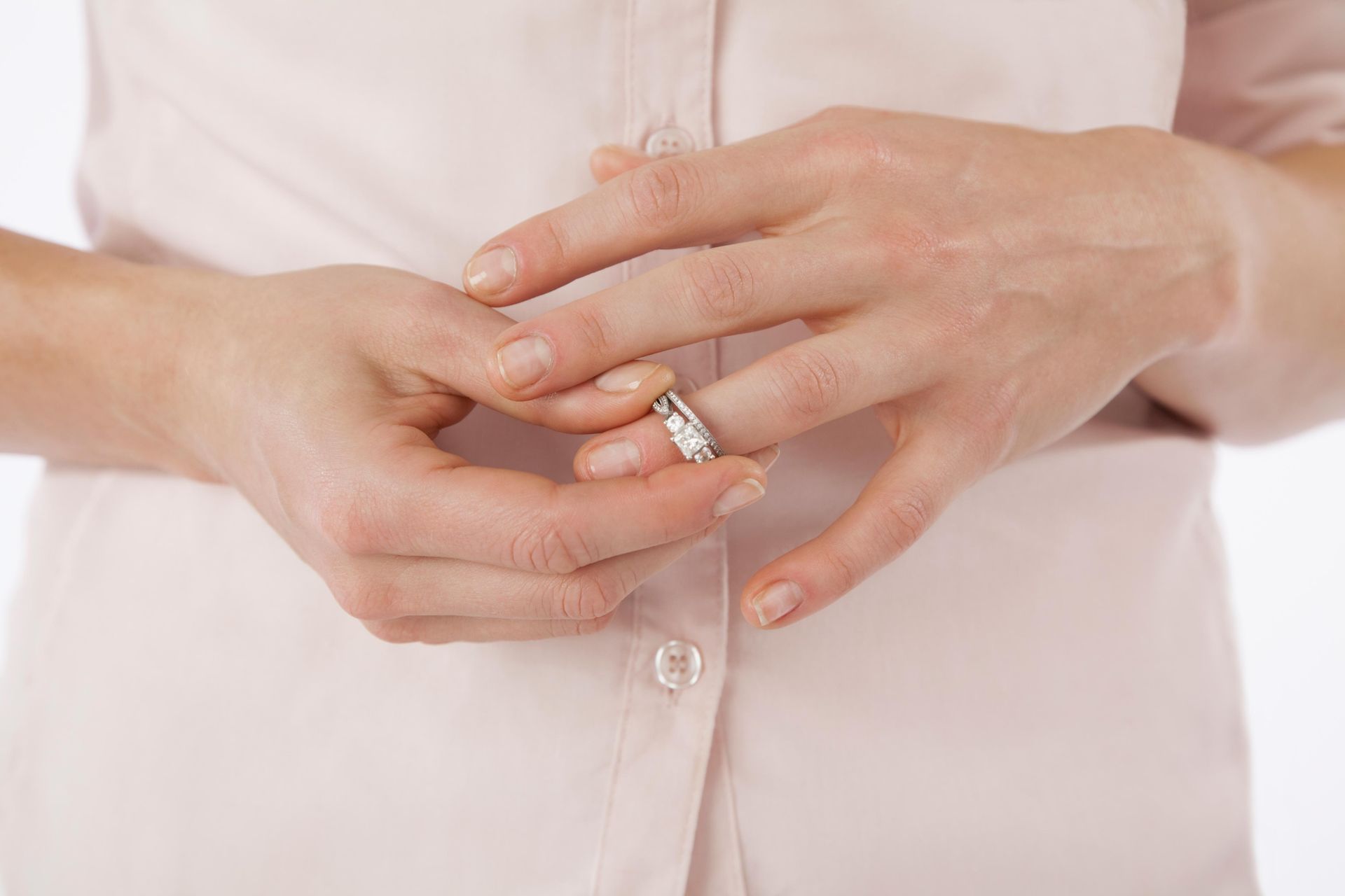 Close-up of woman removing wedding ring from finger