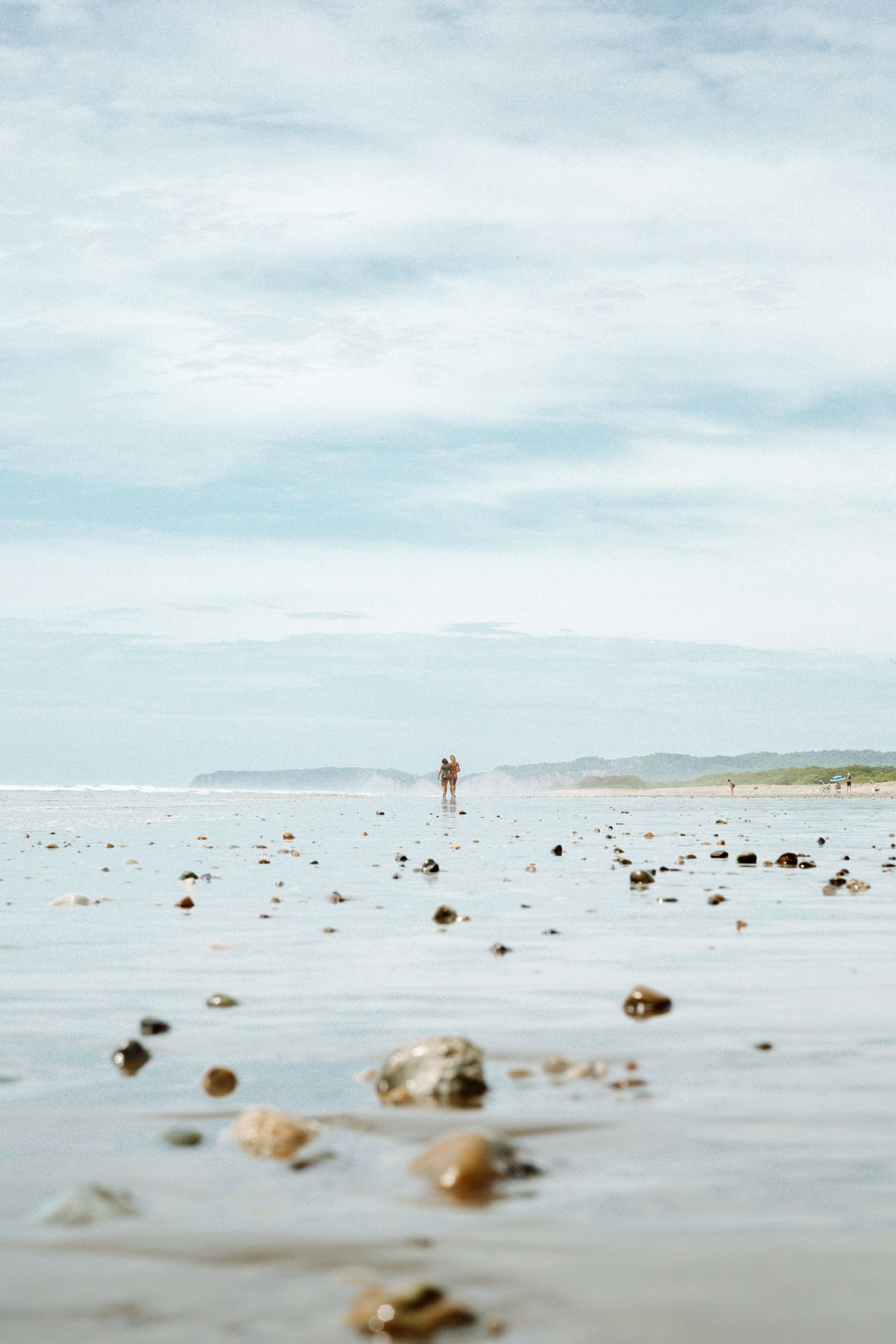 A picture of a beach with rocks in the water.