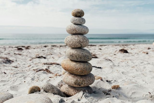 A pile of rocks stacked on top of each other on a beach.