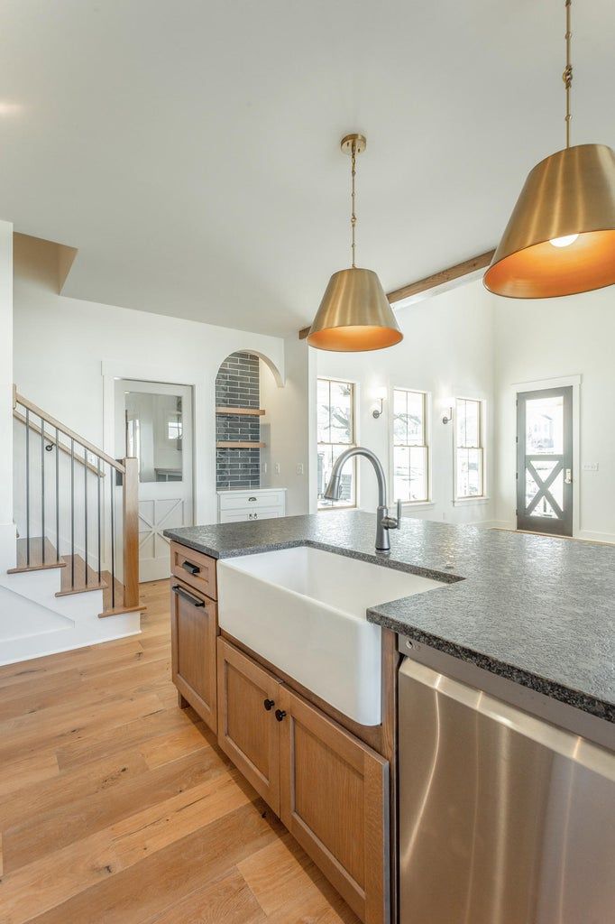 A kitchen with a farmhouse sink and stainless steel appliances.