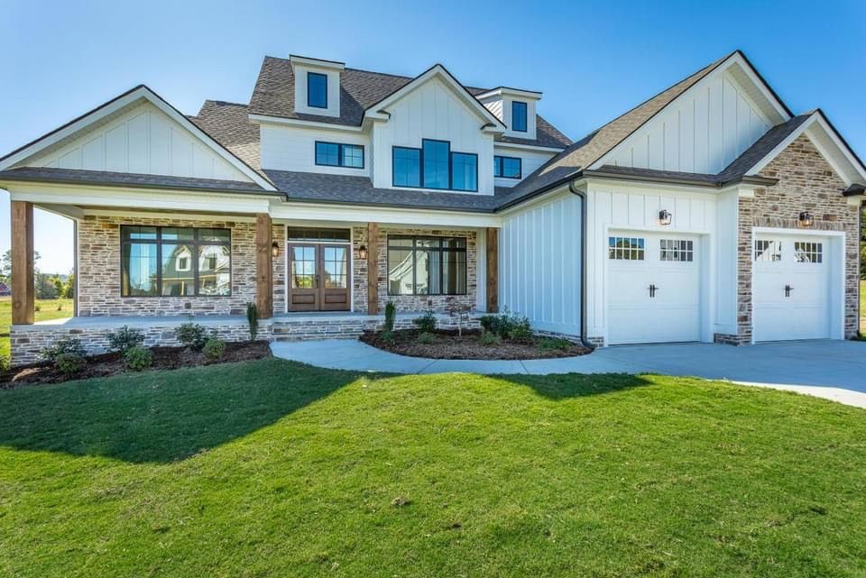 a large white house with a large lawn in front of it .