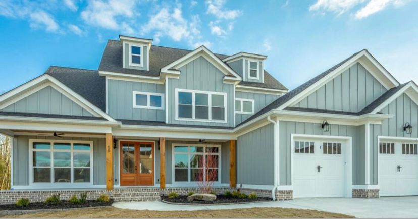 a large house with a lot of windows and a garage .