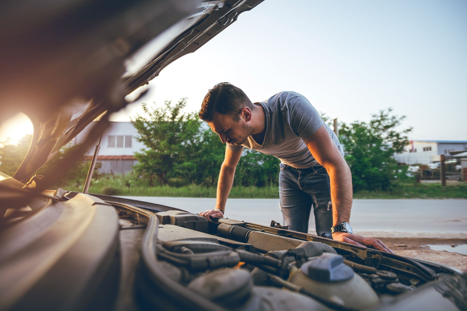 A Man is Looking Under the Hood of a Broken Down Car | Colorado Springs, CO | Locklynn Automotive