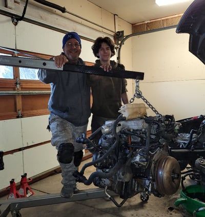 Two Men are Standing Next to a Large Engine in a Garage | Colorado Springs, CO | Locklynn Automotive