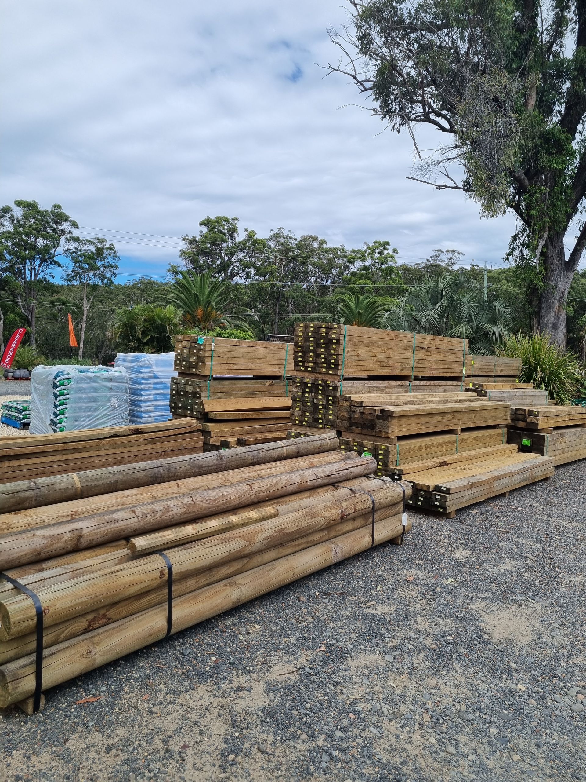 Lumber stacked outdoors on gravel - Palms Landscape Supplies in Forster, NSW
