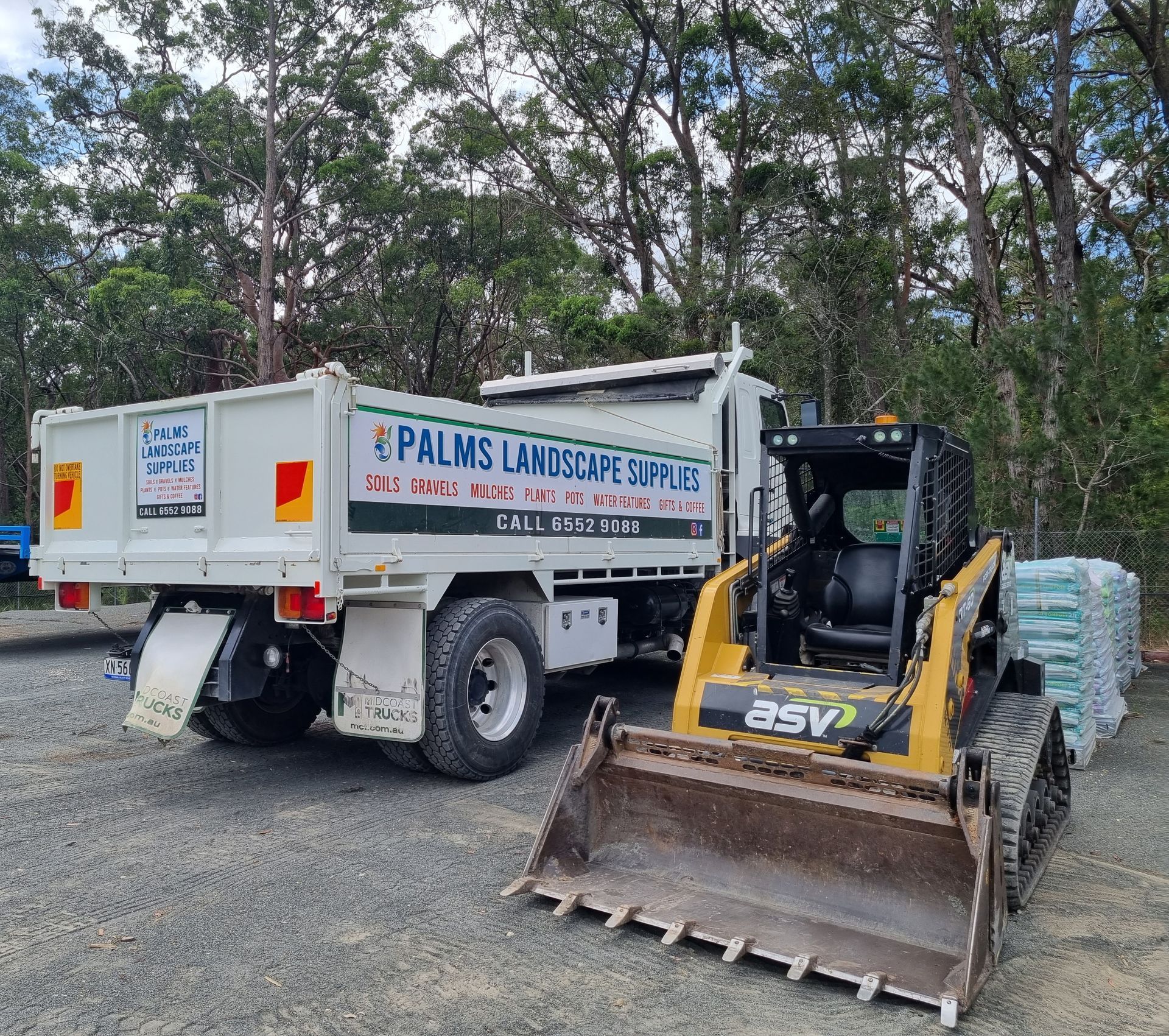 White truck and yellow skid steer - Palms Landscape Supplies in Forster, NSW