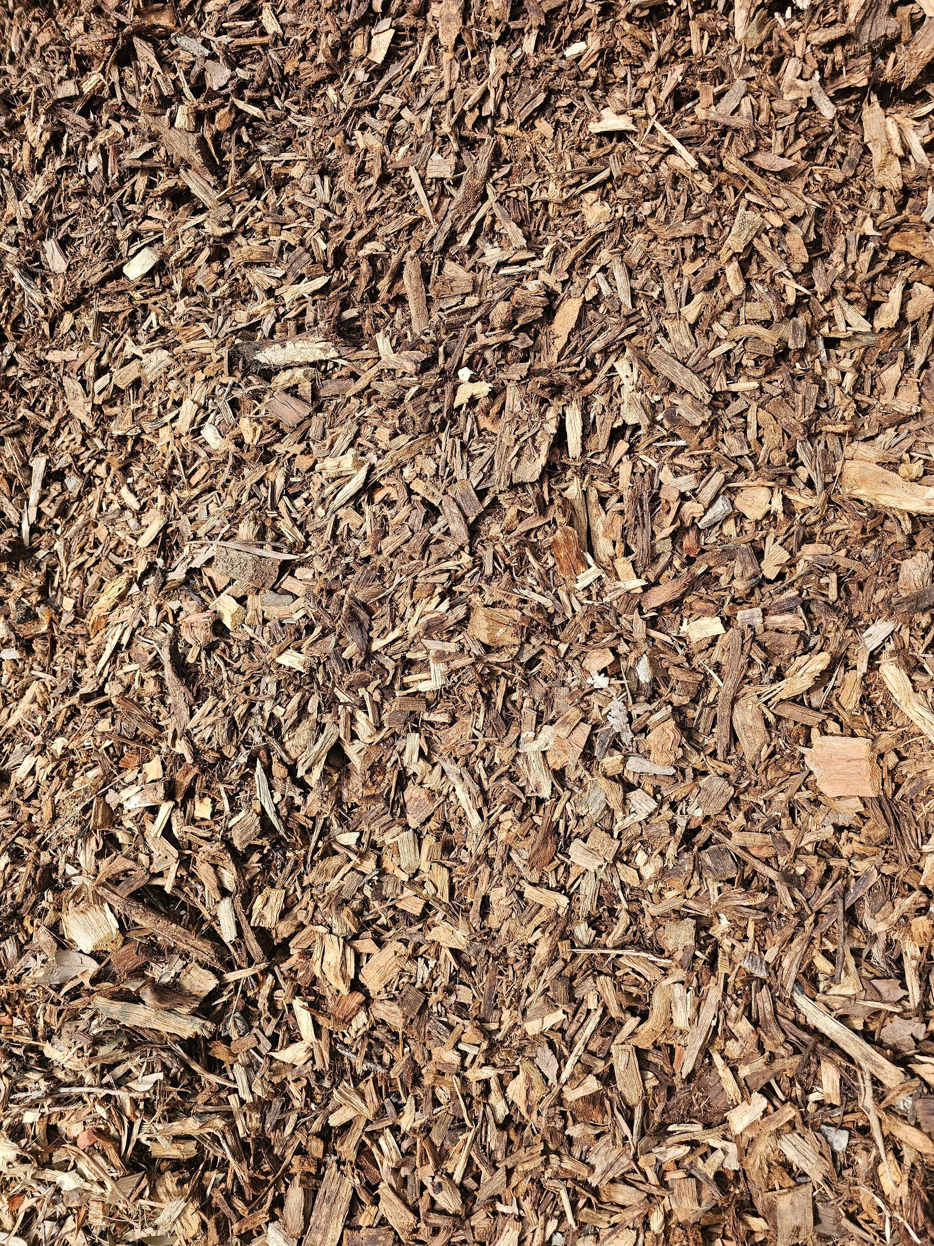 Brown wood chips, covering the ground - Palms Landscape Supplies in Forster, NSW