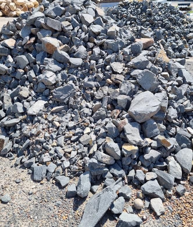 Pile of grey and tan rocks, possibly gravel, outdoors on a sunny day - Palms Landscape Supplies in Forster, NSW