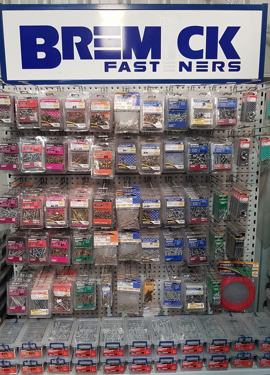Display of packaged fasteners from Bremick at a store, with rows of screws, bolts, and other hardware - Palms Landscape Supplies in Forster, NSW