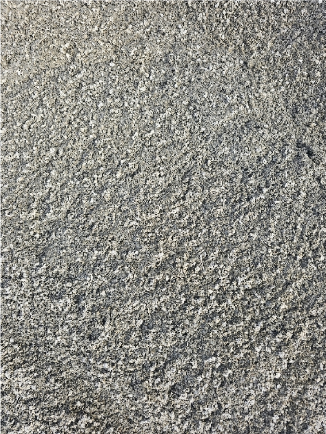 Close-up of rough, grey concrete surface with visible texture and small pebbles - Palms Landscape Supplies in Forster, NSW