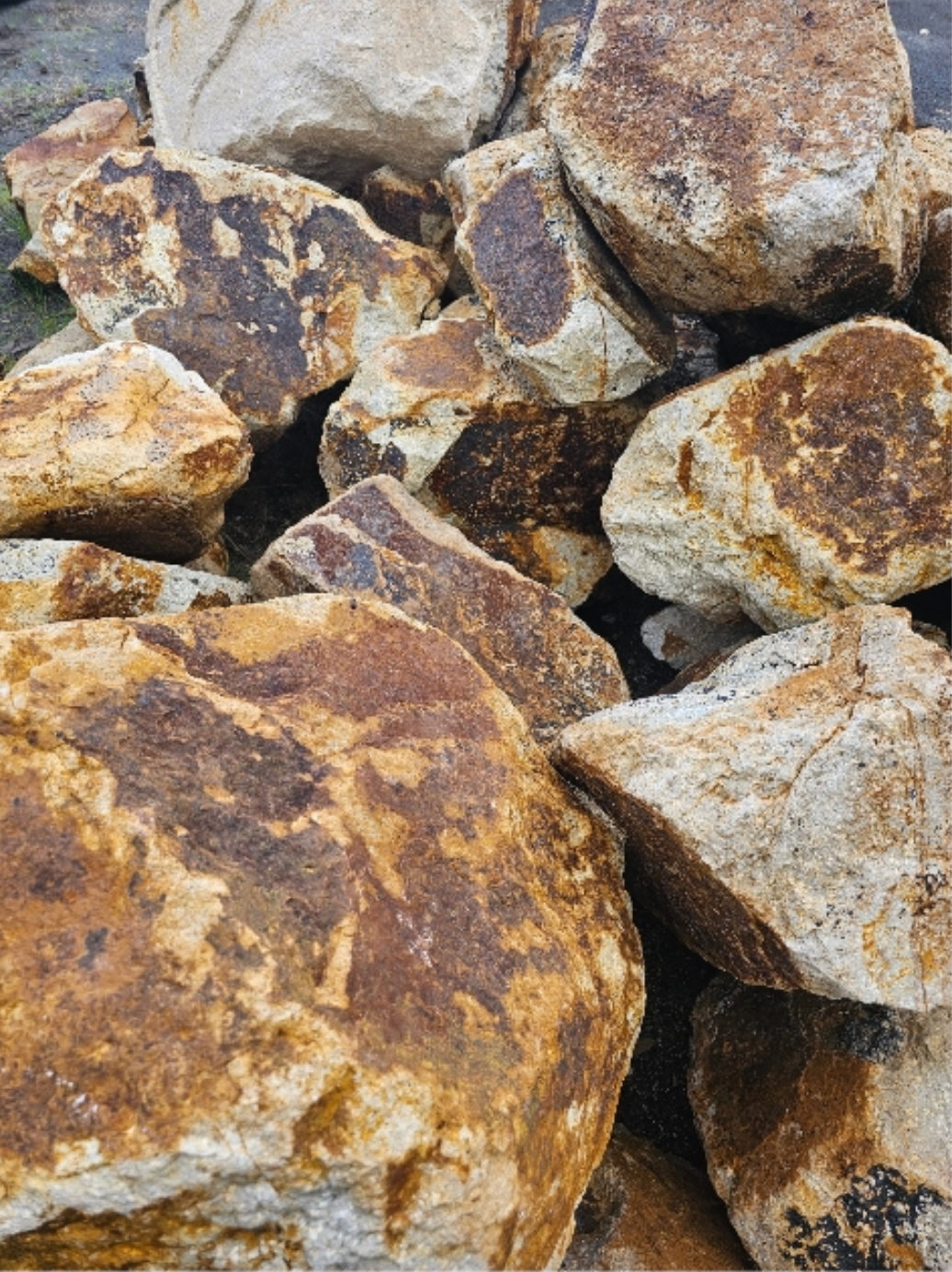 Pile of large, rough-textured, brown and tan rocks; possibly for landscaping - Palms Landscape Supplies in Forster, NSW