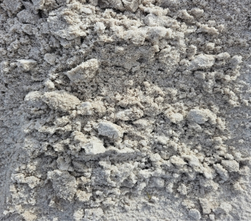 Close-up of a pile of pale grey, textured sand - Palms Landscape Supplies in Forster, NSW