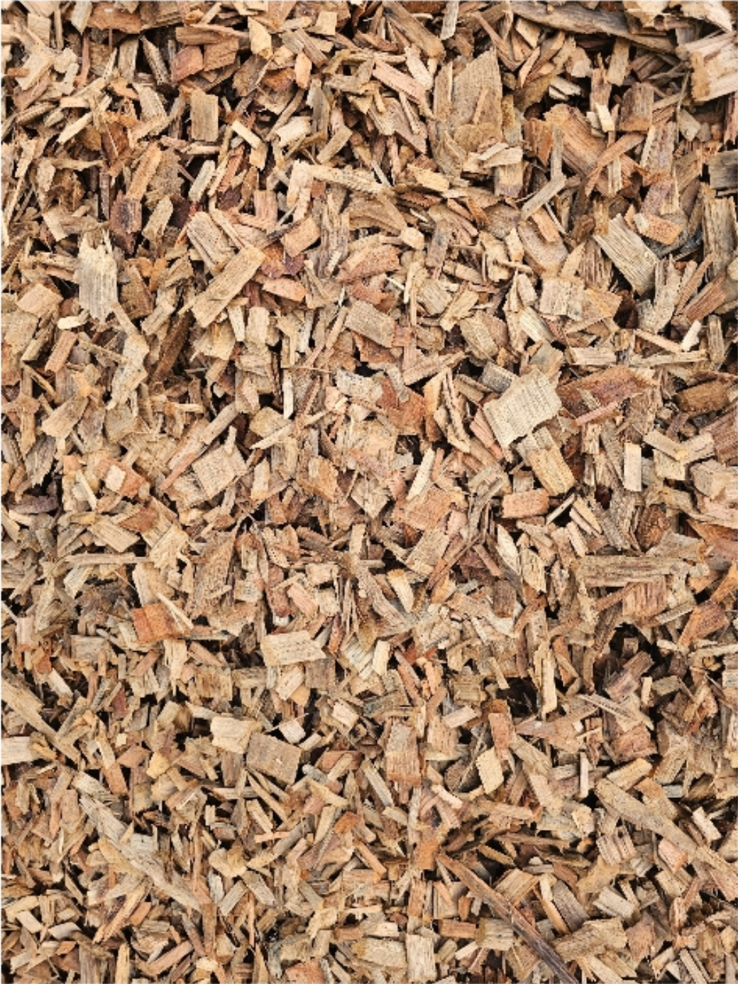 Wood chips, light brown and beige, covering a surface - Palms Landscape Supplies in Forster, NSW