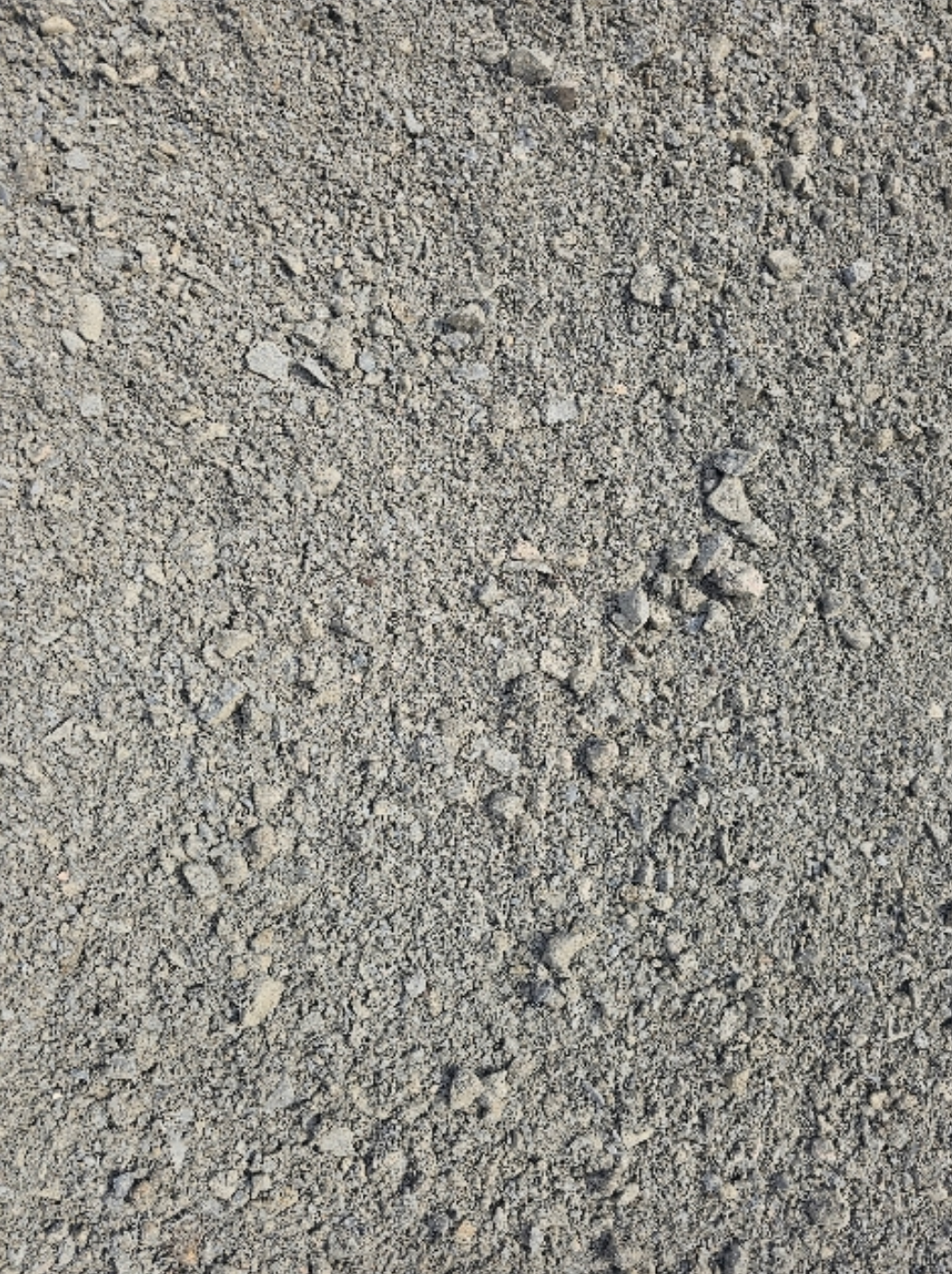Close-up of grey gravel, varying sizes of small stones, under sunlight - Palms Landscape Supplies in Forster, NSW