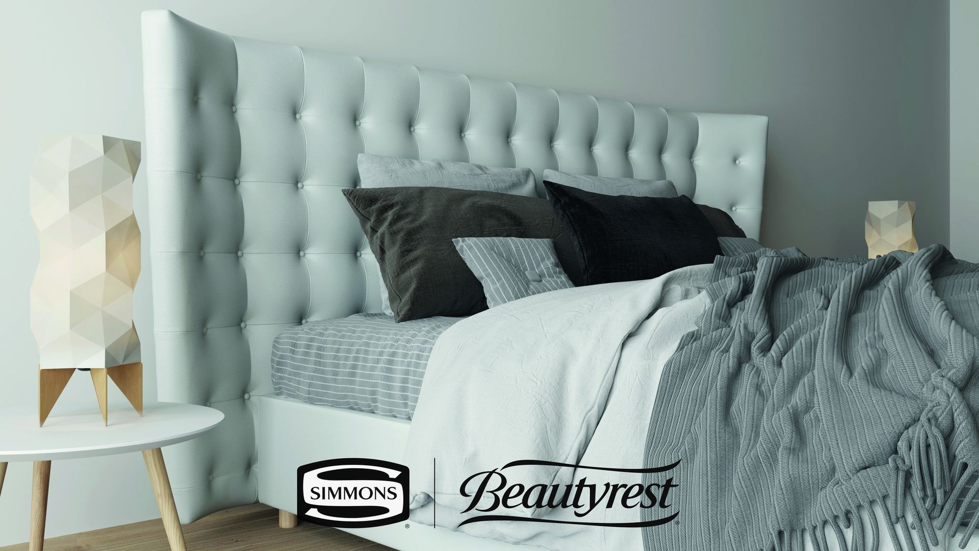 Una camera da letto con un letto e un tavolo con il logo Beautyrest.