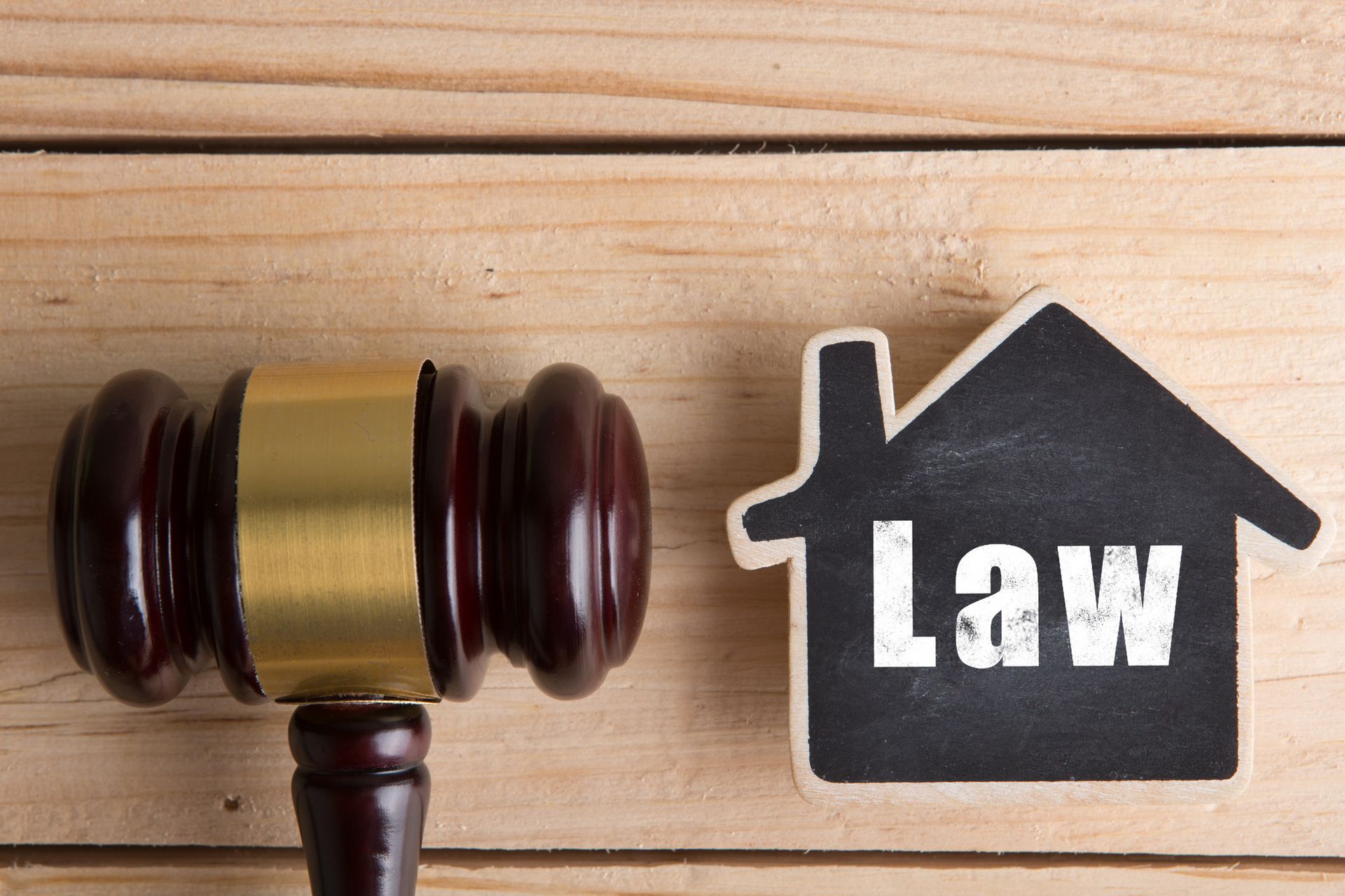 Judge’s gavel with house model illustrating property law and conveyancing steps. Judge’s gavel with house model illustrating property law and conveyancing steps.