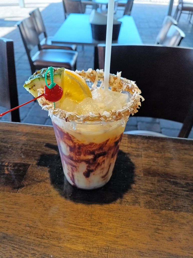 A close up of a drink in a cup on a table.