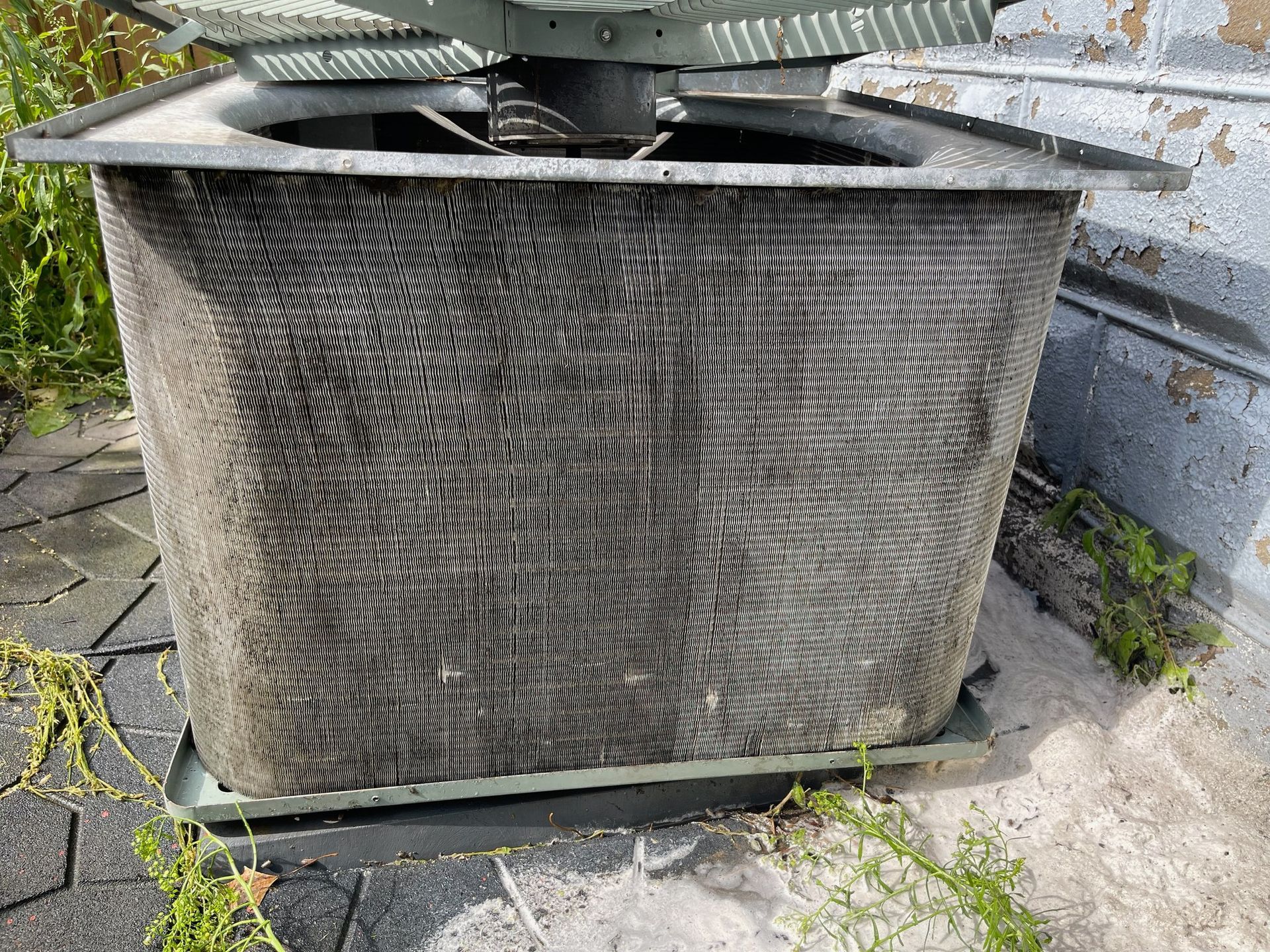 Air conditioning unit with grimy, metal fins.