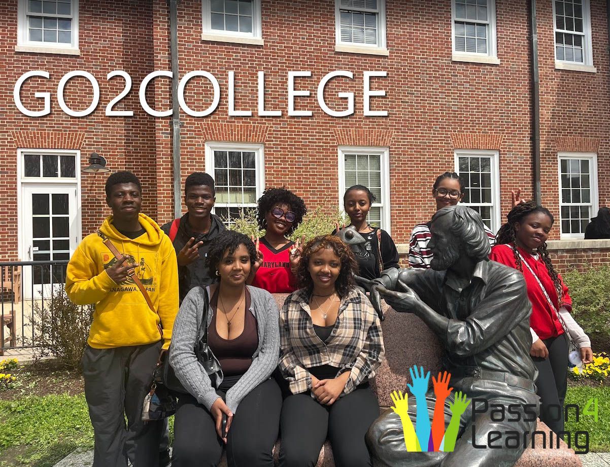 A group of students visiting the Kermit statue at University of Maryland, College Park