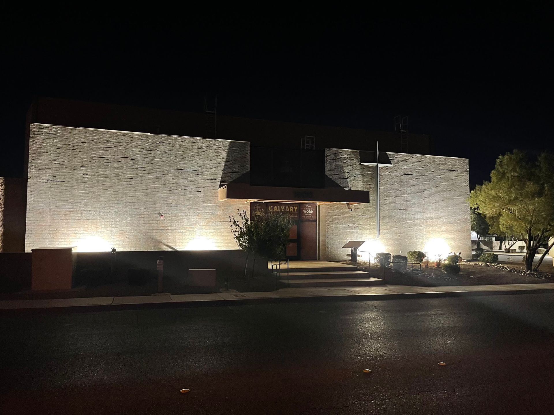 An electrician is working on an electrical box with a screwdriver.