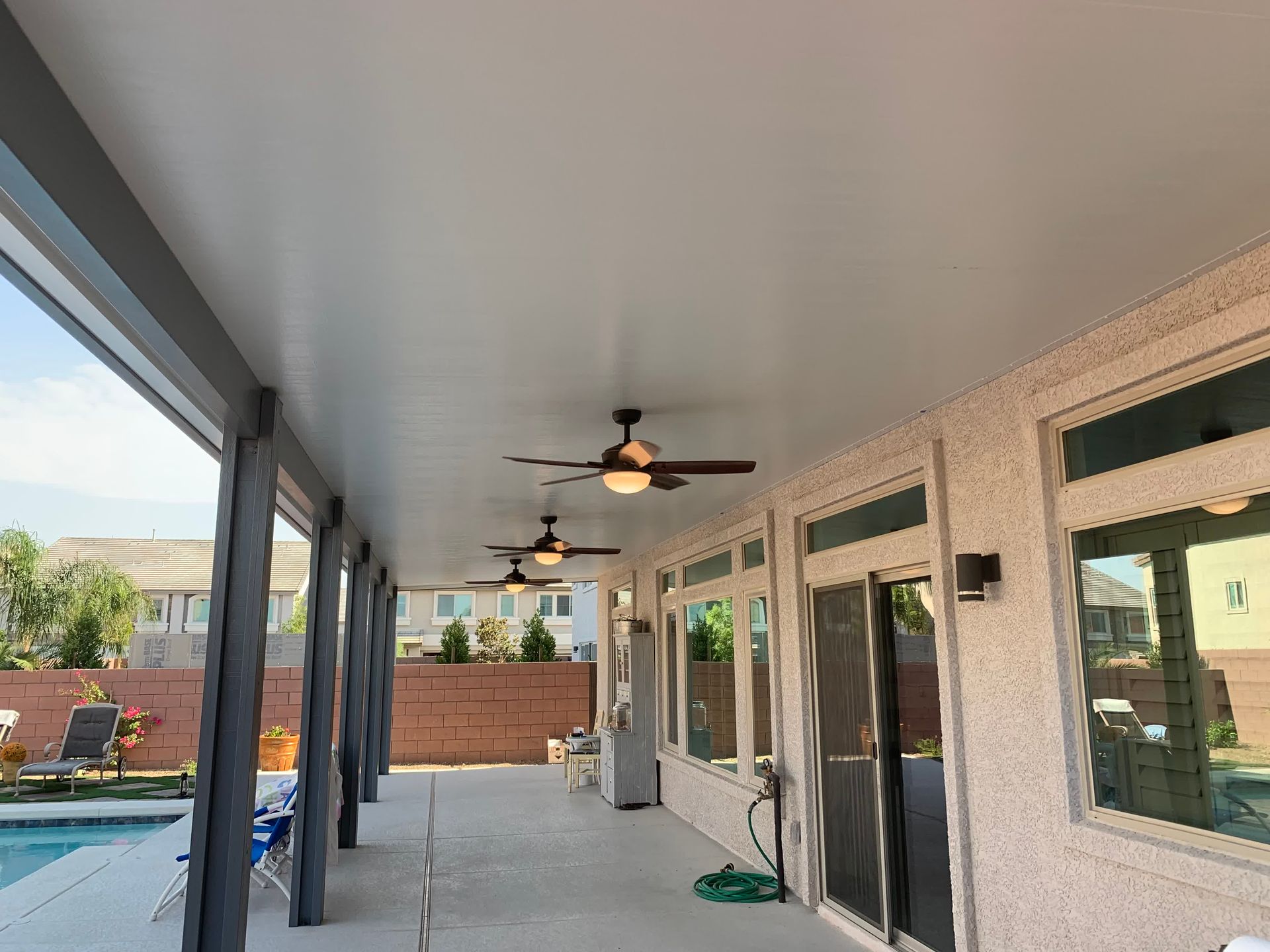An electrician is working on an electrical box with a screwdriver.