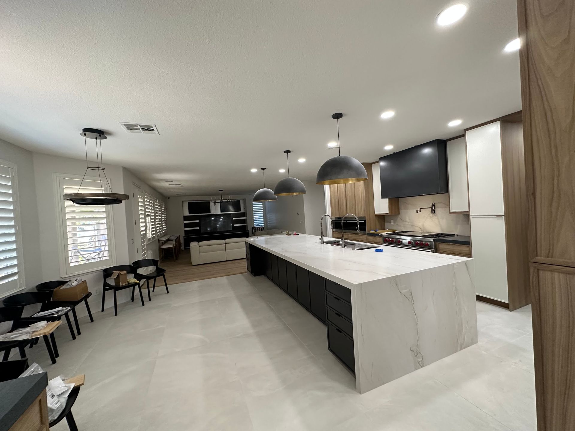 A man wearing gloves is working on an electrical box.