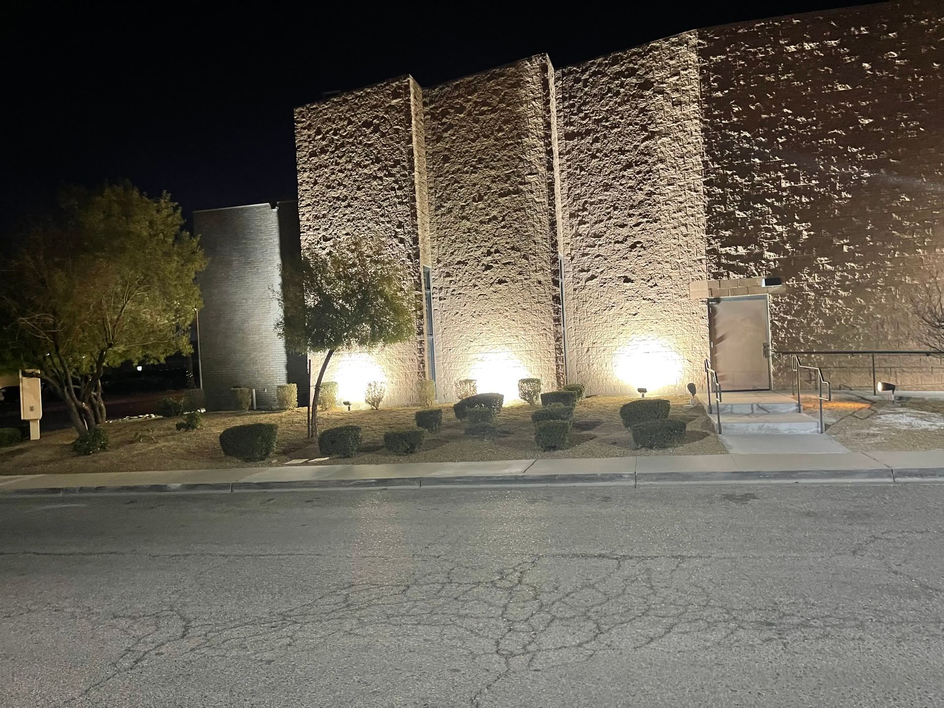 A man wearing gloves is working on an electrical box.