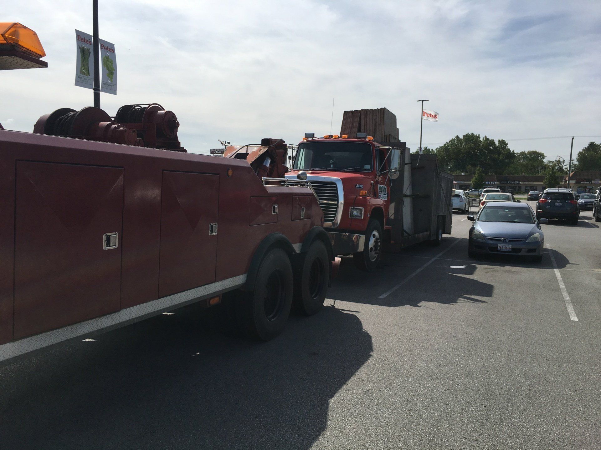 A red tow truck is parked on the side of the road
