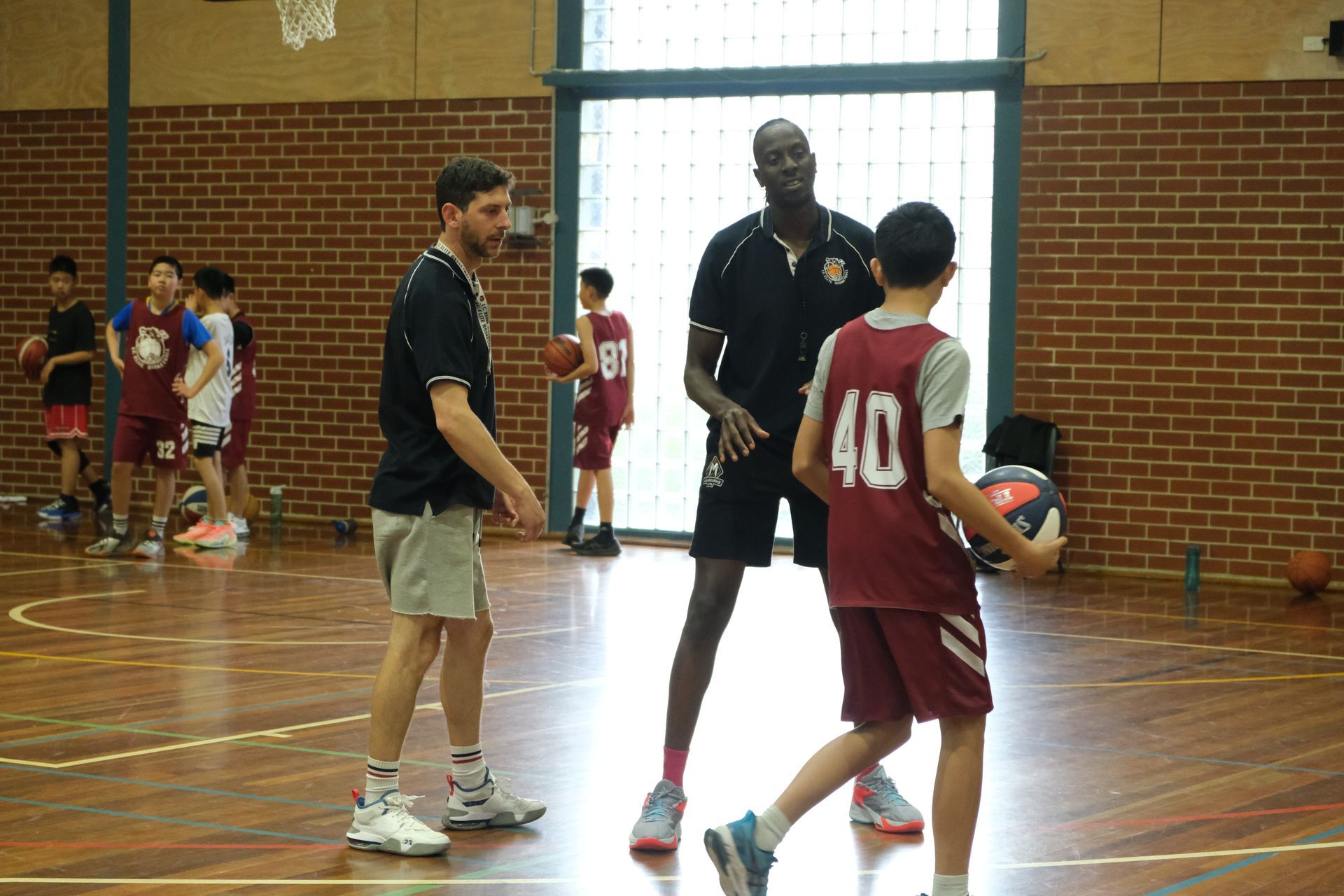 A coach instructing a player  at LC Elite Basketball Academy in Melbourne