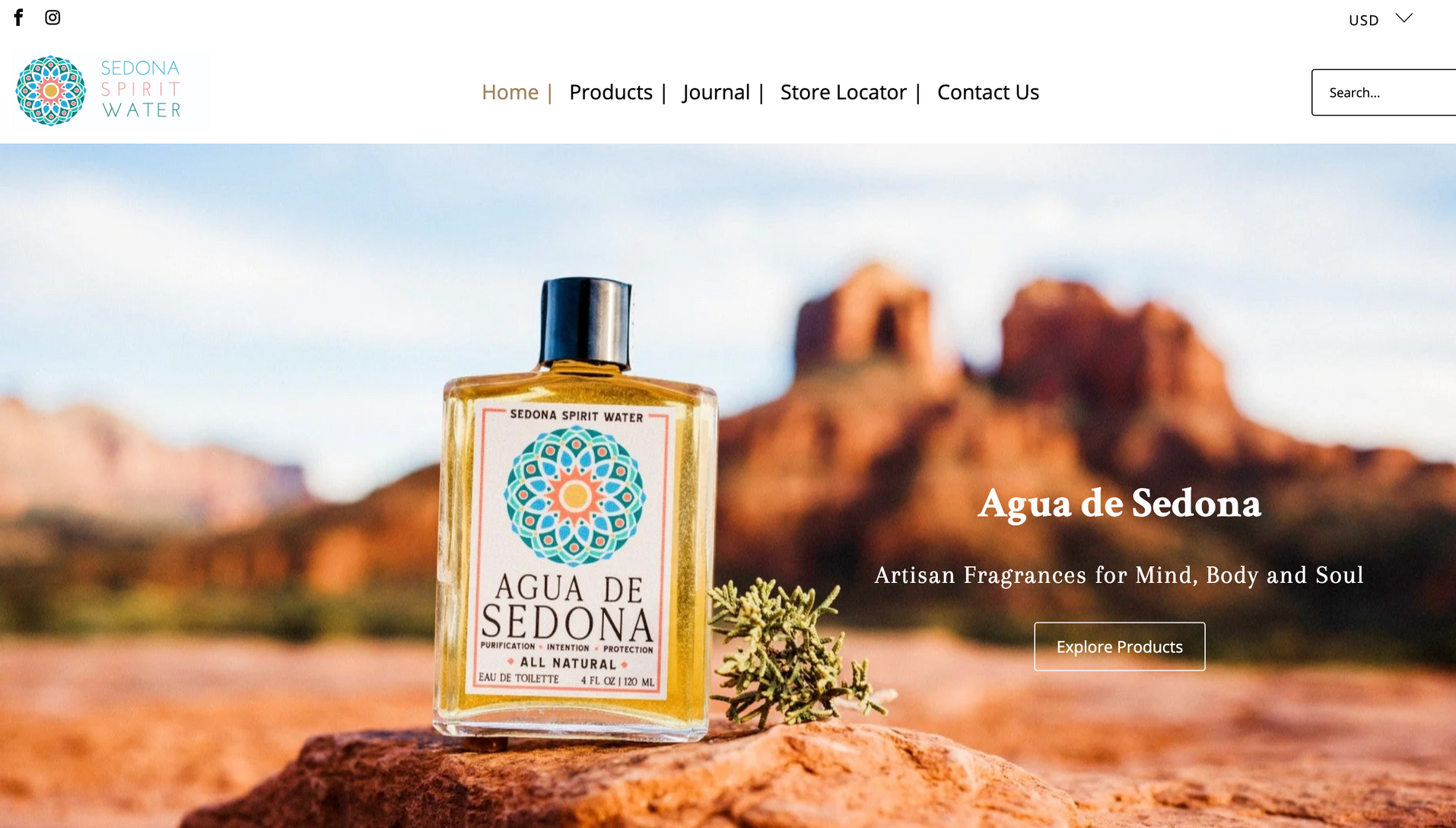 A bottle of perfume is sitting on top of a rock in the desert.