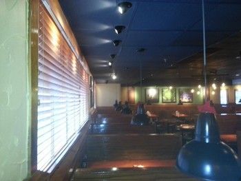 A restaurant with a blue ceiling and wooden blinds