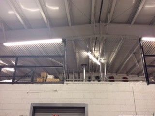 A warehouse with a balcony and boxes on it.