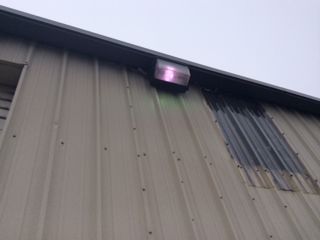 There is a light on the side of a building.