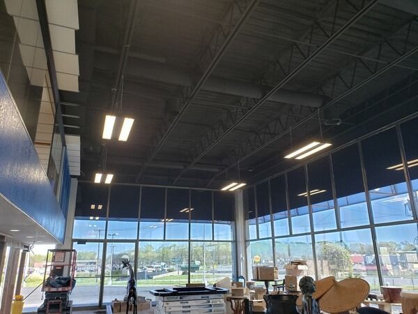 A large room with lots of windows and boxes on the floor